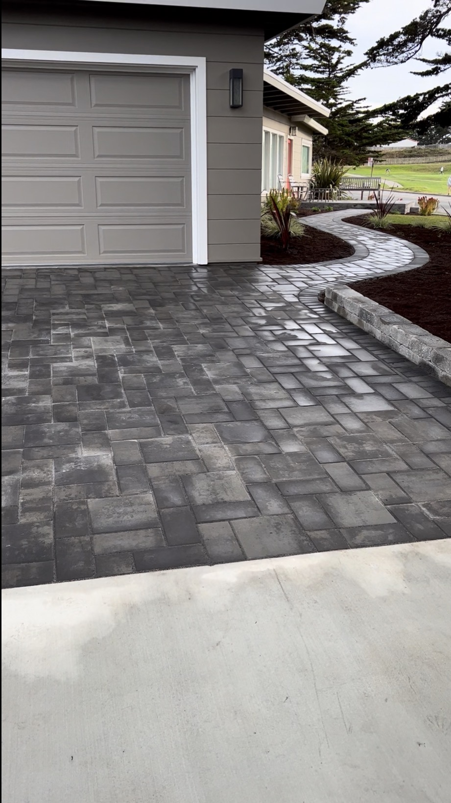 Paver driveway with curved landscape walkway